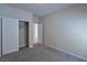 Bright bedroom featuring neutral walls, carpet, and sliding-door closet at 8324 S Miller Ln, Las Vegas, NV 89113
