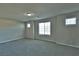 A spacious bedroom features neutral walls, large windows, and soft carpeted floors at 8324 S Miller Ln, Las Vegas, NV 89113