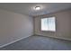 Neutral carpeted bedroom featuring a window with blinds, allowing natural light to filter in at 8324 S Miller Ln, Las Vegas, NV 89113