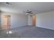 Large bedroom with carpet, ceiling fan, and entrances to ensuite bathroom and hallway at 8324 S Miller Ln, Las Vegas, NV 89113
