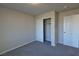 This bedroom features neutral walls, carpeted floors, and a closet for optimal storage at 8324 S Miller Ln, Las Vegas, NV 89113