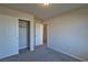 This bedroom features neutral walls, carpeted floors, and a closet for optimal storage at 8324 S Miller Ln, Las Vegas, NV 89113