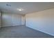 A spacious bonus room features neutral walls, soft carpeted floors, and a ceiling light at 8324 S Miller Ln, Las Vegas, NV 89113