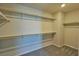 Walk-in closet with built-in shelving and carpet flooring at 8324 S Miller Ln, Las Vegas, NV 89113