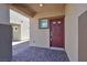 Covered entryway featuring tile flooring and a stylish red front door with glass detailing at 8324 S Miller Ln, Las Vegas, NV 89113