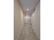 Hallway with tile flooring, neutral walls, and access to multiple rooms, including the entryway at 8324 S Miller Ln, Las Vegas, NV 89113
