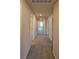 Long hallway with neutral walls and carpet flooring leads to various rooms, lit by recessed lighting at 8324 S Miller Ln, Las Vegas, NV 89113