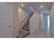Hallway with carpeted stairs, tile flooring, and neutral walls leading to the upper level at 8324 S Miller Ln, Las Vegas, NV 89113