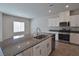 Open kitchen boasts a large island with granite countertops and stainless steel appliances at 8324 S Miller Ln, Las Vegas, NV 89113