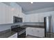 Modern kitchen features stainless steel appliances, granite countertops, and white cabinetry at 8324 S Miller Ln, Las Vegas, NV 89113