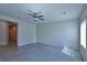 Living area featuring tile flooring, ceiling fan and an adjacent hallway at 8324 S Miller Ln, Las Vegas, NV 89113