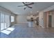 Bright open-concept floor plan with tile flooring, white cabinetry, and modern appliances at 8324 S Miller Ln, Las Vegas, NV 89113