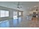 Open-concept living space featuring tile floors, ceiling fan and patio access at 8324 S Miller Ln, Las Vegas, NV 89113