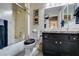 Updated bathroom featuring a granite vanity, shower over tub, and modern fixtures at 8808 Litchfield Ave, Las Vegas, NV 89134