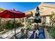 Charming courtyard features an outdoor sitting area, umbrellas, and lush landscaping at 8808 Litchfield Ave, Las Vegas, NV 89134