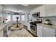Bright kitchen with stainless steel appliances, white cabinets, granite countertops, and a breakfast nook at 8808 Litchfield Ave, Las Vegas, NV 89134