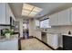 Open concept kitchen with stainless steel appliances, tile backsplash, granite counters, and natural light at 8808 Litchfield Ave, Las Vegas, NV 89134