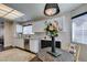Bright kitchen and breakfast nook with granite countertops, a view, and modern fixtures at 8808 Litchfield Ave, Las Vegas, NV 89134