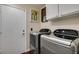 A well-lit laundry room equipped with a front loading washer and dryer at 8808 Litchfield Ave, Las Vegas, NV 89134