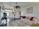 Relaxing living room design, complete with a neutral sofa, modern fan, and dark wood flooring at 8808 Litchfield Ave, Las Vegas, NV 89134