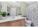 Well-maintained bathroom featuring a sink, vanity, toilet, and shower with curtain at 9013 Meisenheimer Ave, Las Vegas, NV 89143