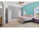 Bright bedroom featuring cool-toned walls, plush carpet, a ceiling fan and two large windows for lots of light at 9013 Meisenheimer Ave, Las Vegas, NV 89143