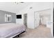 Bright bedroom featuring white walls, plush carpet, a ceiling fan and access to the Primary bathroom at 9013 Meisenheimer Ave, Las Vegas, NV 89143