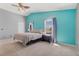 Bright bedroom featuring cool-toned walls, plush carpet, a ceiling fan and two large windows that let in natural light at 9013 Meisenheimer Ave, Las Vegas, NV 89143