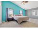 Bright bedroom featuring cool-toned walls, plush carpet, a ceiling fan and two large windows with stylish curtains at 9013 Meisenheimer Ave, Las Vegas, NV 89143