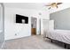 Bright bedroom featuring white walls, plush carpet, a ceiling fan and access to the Primary bathroom at 9013 Meisenheimer Ave, Las Vegas, NV 89143