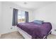 Bright bedroom featuring a cozy bed, soft carpet, and window with views at 9013 Meisenheimer Ave, Las Vegas, NV 89143