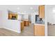 Open kitchen layout featuring wood cabinets, tile countertops, and modern appliances at 9013 Meisenheimer Ave, Las Vegas, NV 89143