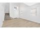 Open-concept living area with light flooring and view of the stairway to the second level at 9013 Meisenheimer Ave, Las Vegas, NV 89143