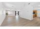 Spacious living area that connects to the kitchen, featuring continuous flooring and large windows at 9013 Meisenheimer Ave, Las Vegas, NV 89143