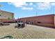 Private backyard with ample seating and outdoor kitchen under a clear blue sky at 9045 Knots Estate St, Las Vegas, NV 89139