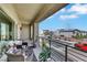 Relaxing balcony with outdoor seating and neighborhood views under a sunny sky at 9045 Knots Estate St, Las Vegas, NV 89139