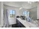 Bathroom featuring a large vanity with double sinks, a large mirror and a shower/tub combo at 9045 Knots Estate St, Las Vegas, NV 89139