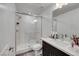 Bathroom featuring a glass-enclosed walk-in shower, marble-look shower surround, and vanity with white countertop at 9045 Knots Estate St, Las Vegas, NV 89139