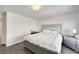 Simple bedroom featuring a bed with a silver frame, carpet, and a silver nightstand at 9045 Knots Estate St, Las Vegas, NV 89139