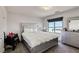 Bright bedroom featuring a bed with a silver frame, carpet, and a silver nightstand at 9045 Knots Estate St, Las Vegas, NV 89139