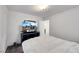Cozy bedroom with a TV, dresser, and a view to another part of the home at 9045 Knots Estate St, Las Vegas, NV 89139