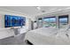 Spacious bedroom boasts expansive windows, a large TV, and a comfortable king bed for relaxation and entertainment at 9045 Knots Estate St, Las Vegas, NV 89139