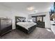 Relaxing bedroom features plush carpeting, modern furniture, and a sleek TV for ultimate comfort and entertainment at 9045 Knots Estate St, Las Vegas, NV 89139
