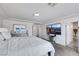 Bright bedroom features a large bed, a modern TV, and a vanity making it the perfect place to unwind and relax at 9045 Knots Estate St, Las Vegas, NV 89139