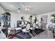 An elegant dining room with modern decor, marble floors, recessed lighting, and a view to other rooms at 9045 Knots Estate St, Las Vegas, NV 89139