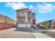 Beautiful three-story home with a three-car garage and a charming pink door at 9045 Knots Estate St, Las Vegas, NV 89139