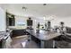 Spacious kitchen featuring dark cabinets, large island and bright windows at 9045 Knots Estate St, Las Vegas, NV 89139