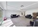 Large living room with neutral carpet, recessed lighting, and two dark-colored couches at 9045 Knots Estate St, Las Vegas, NV 89139