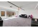 Large living room with bright windows and access to backyard patio at 9045 Knots Estate St, Las Vegas, NV 89139