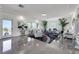 Bright living room with modern decor, marble floors, recessed lighting, and a large sliding door to the exterior at 9045 Knots Estate St, Las Vegas, NV 89139